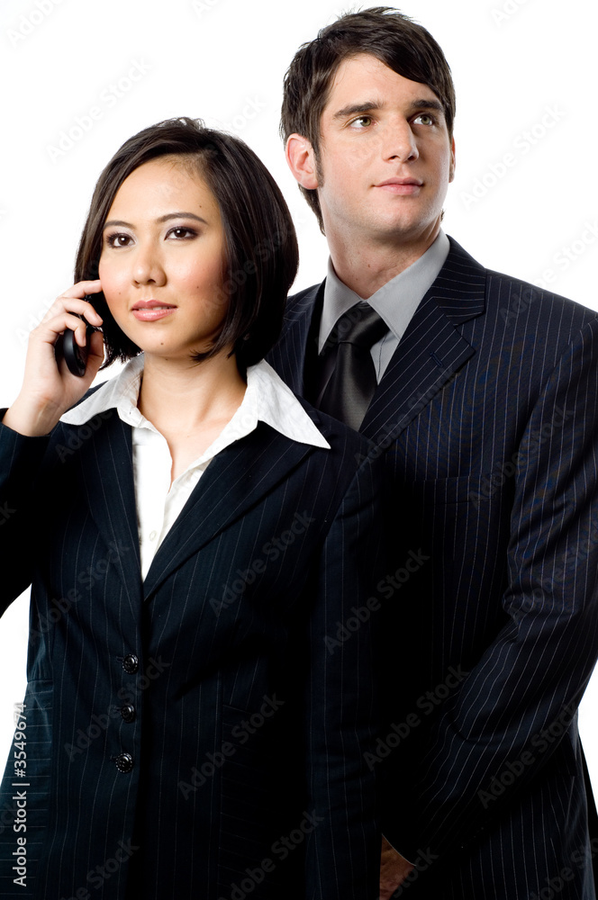 Two young business people with mobile phones on white background