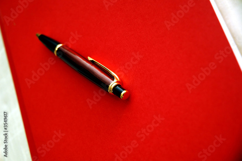 Red notebook and luxury pen