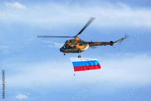 military helicopter flying with Russian Federation flag