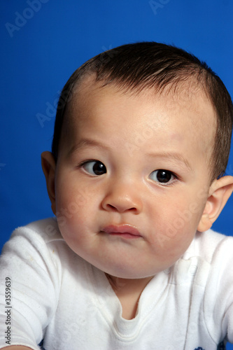 Baby boys makes a face.