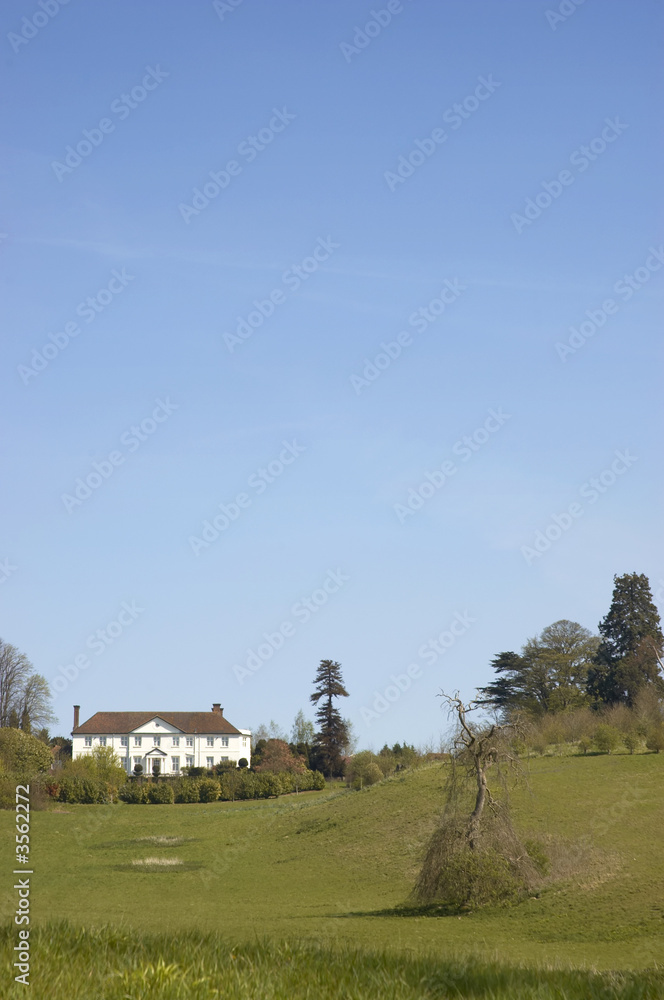  A view of a large house on top of a hill