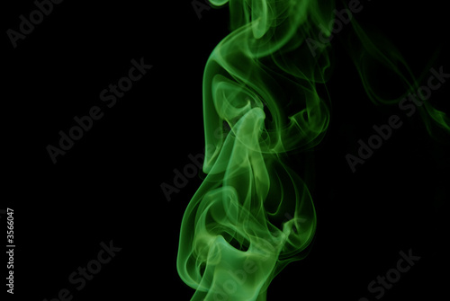 Green Smoke abstract on black background .
