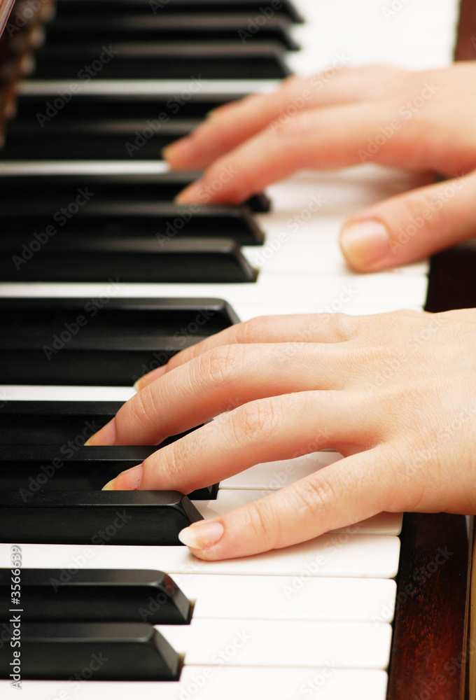 Two hands playing music on the  piano