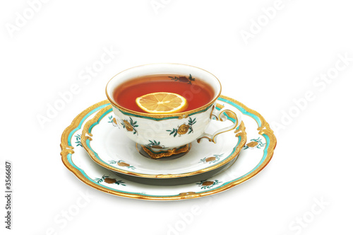 Принти на полотні Tea with lemon and saucers isolated on the white