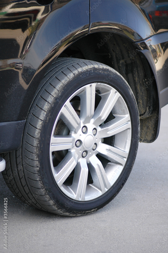 Car tyre of a shiny black car