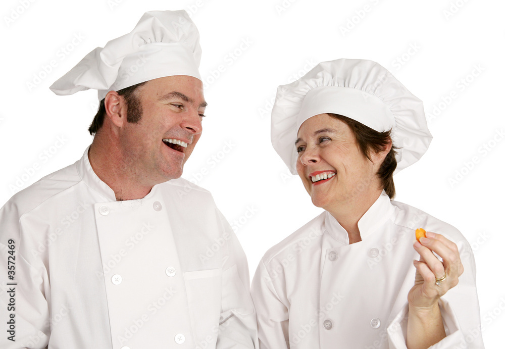 A male and female chef laughing together