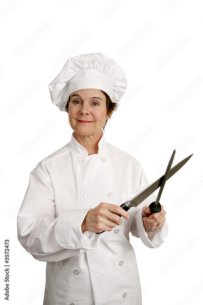 A female chef sharpening knife A female chef sharpening knife