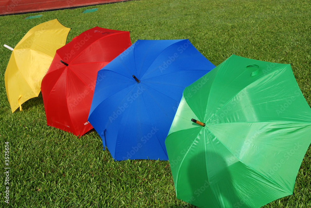 Colorful umbrellas on the football field 
