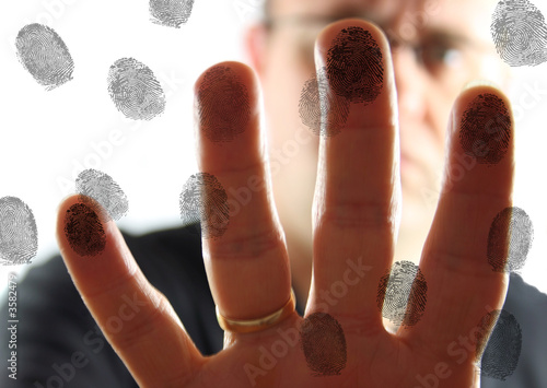 Man leaving fingerprints on glass.
