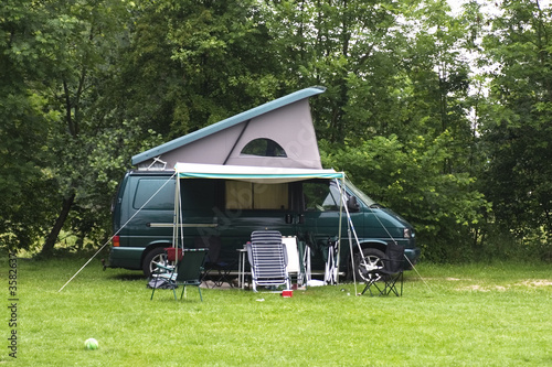 green camper van on a campsite