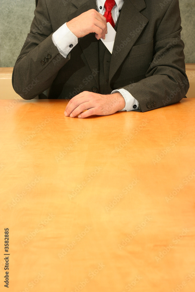 Business-man sitting at the desk, introducing himself.