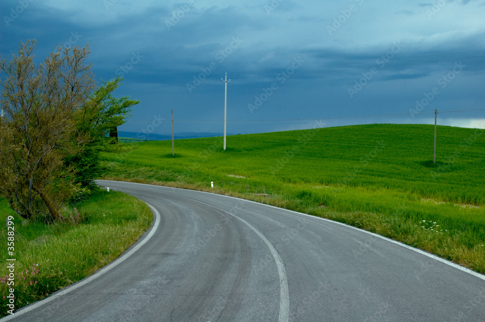 Country road in Tuscany region of Italy.  Oncoming storm.