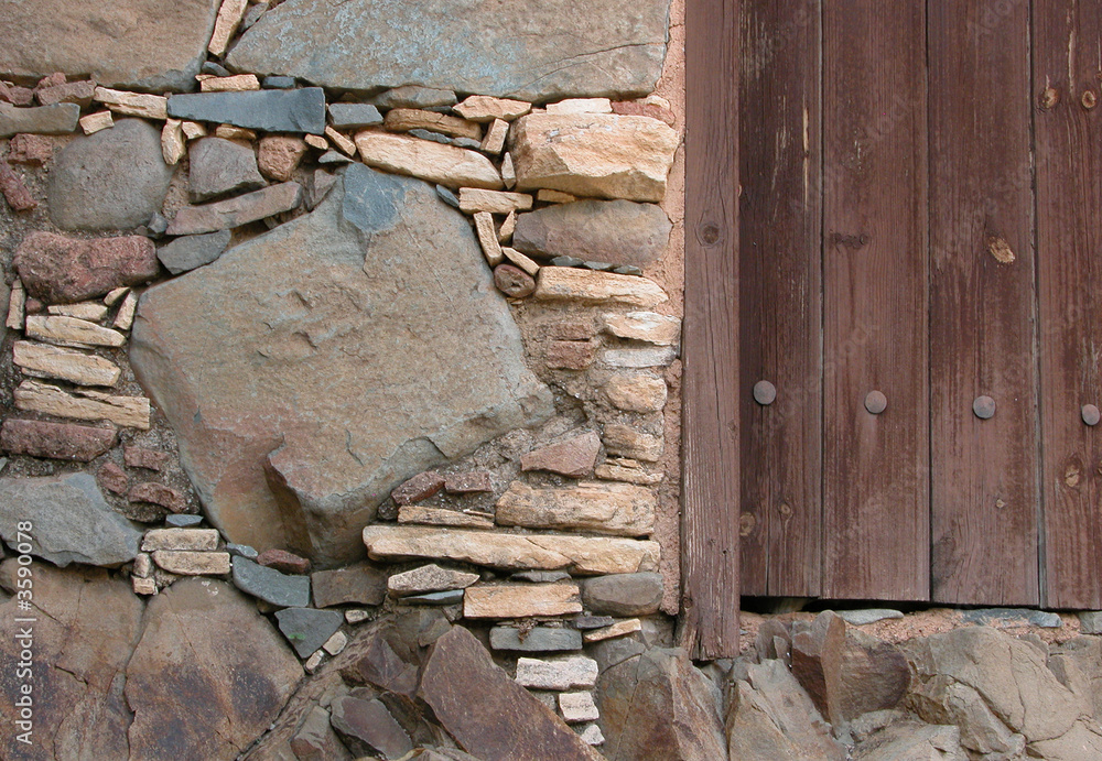 Fototapeta premium Stone wall and wooden door
