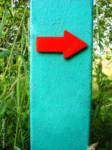Red Sign Pointing The Way To The RIght