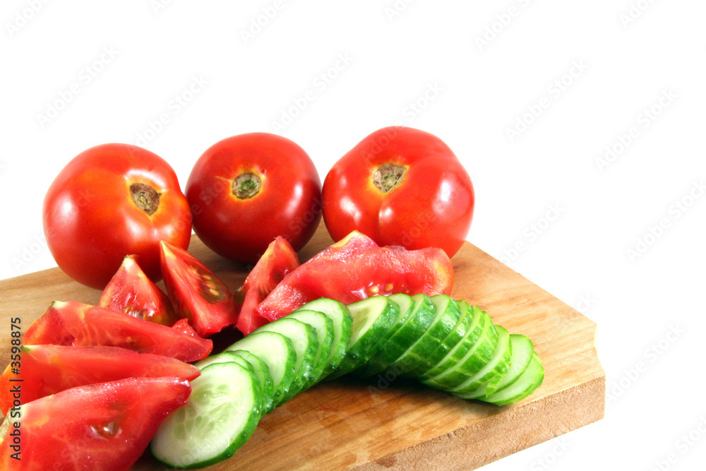 tomatos and cucumbers on a wooden plate isolated on white tomatos and cucumbers on a wooden plate isolated on white