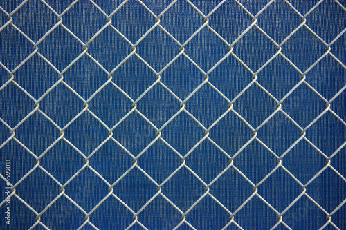 Metal chainlink grid fence over plastic blue