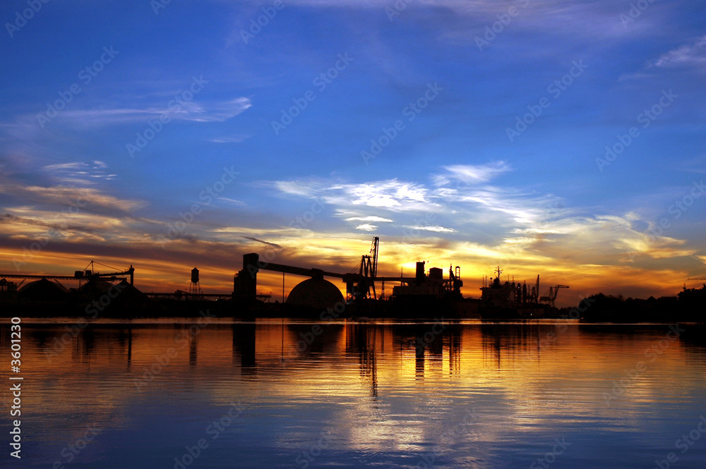Cargo Ship Silhouette Reflected near Seaport Loading Docks