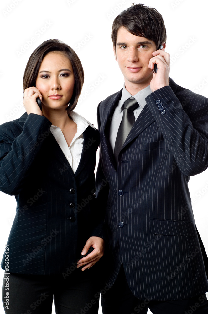 Two young business peopel with mobile phones on white background Two young business peopel with mobile phones on white background