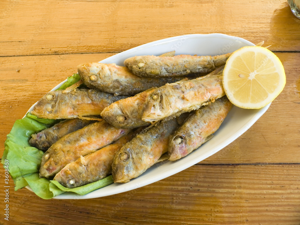Appetizing snack a fried fish with a lemon Appetizing snack a fried fish with a lemon