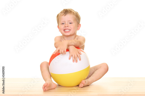 three years old boy and pool ball isolated on white photo