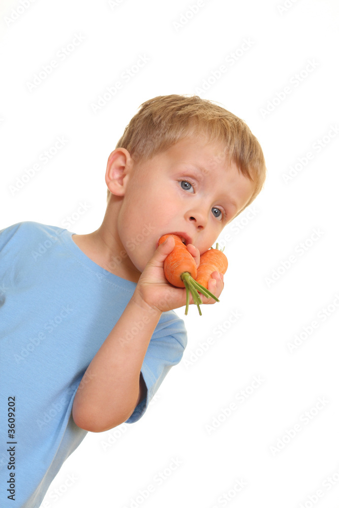 three years old boy eating fresh carrot isolated on white three years old boy eating fresh carrot isolated on white