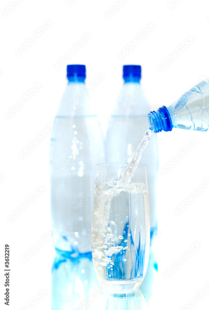 Bottles of mineral water with a glass. Isolated Bottles of mineral water with a glass. Isolated