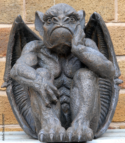 Fotografia, Obraz Scary looking Gargoyle sitting inside his wings