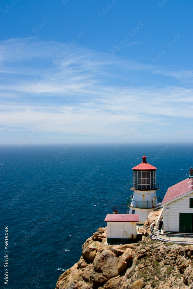 Bluesky seascape with lighthouse on remote cape Bluesky seascape with lighthouse on remote cape