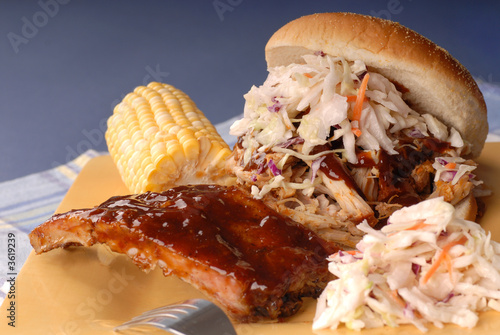Pulled pork sandwich with cole slaw  with ribs, corn and beans