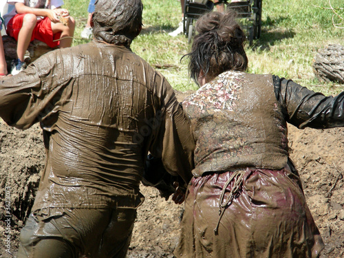 Couple competing in a mud wrestling contest at a local fair photo