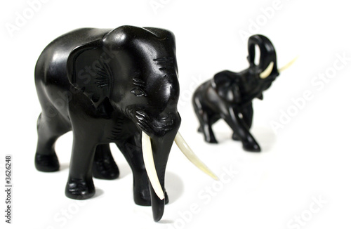 Fototapeta Naklejka Na Ścianę i Meble -  Hand carved black elephants in formation.