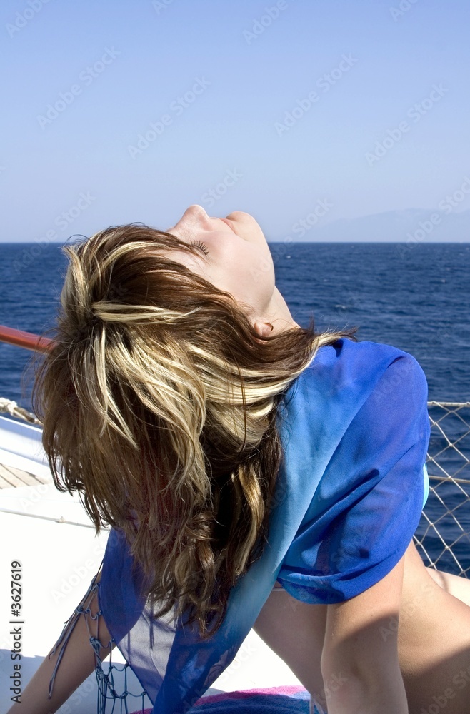 Young beautiful girl on a yacht