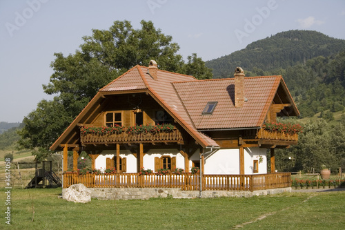 Wooden mountain house in summer time