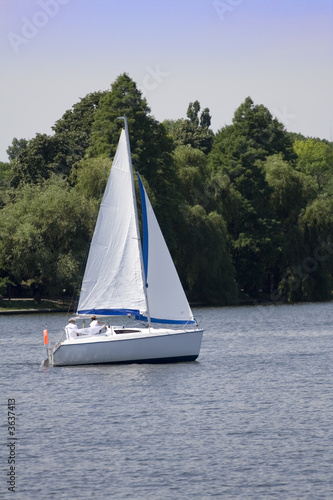 Relaxing by sailing with a little pleasure yach on a lake