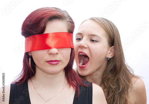 Two girls screaming to another