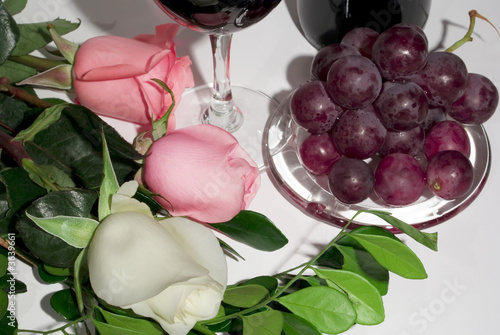 Roses, bunch of grapes and wine