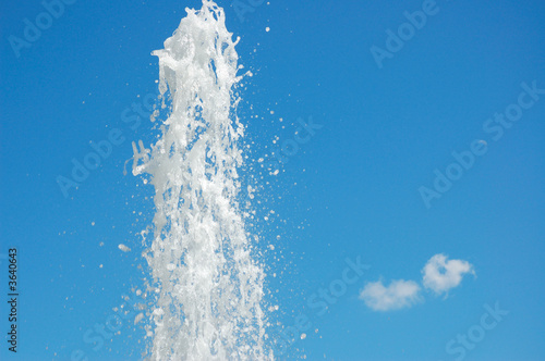 Fountain of water on a background blue sky