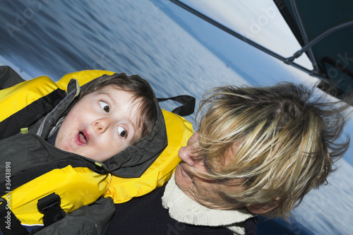 baby with grandmother on a boat doing faces