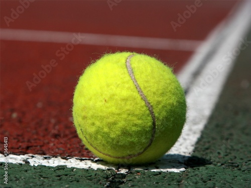Tennis ball in the corner of a tennis field