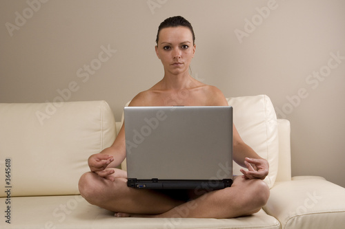 Woman meditating with a laptop