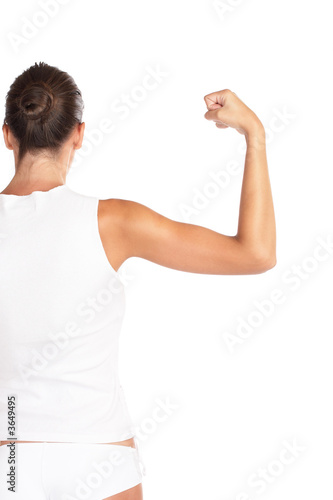 Beautiful woman flexing biceps - high key shot in studio