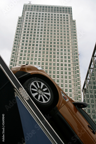 Fototapeta car pointing towards office building