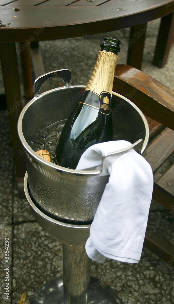 An open bottle of champagne in an ice bucket An open bottle of champagne in an ice bucket