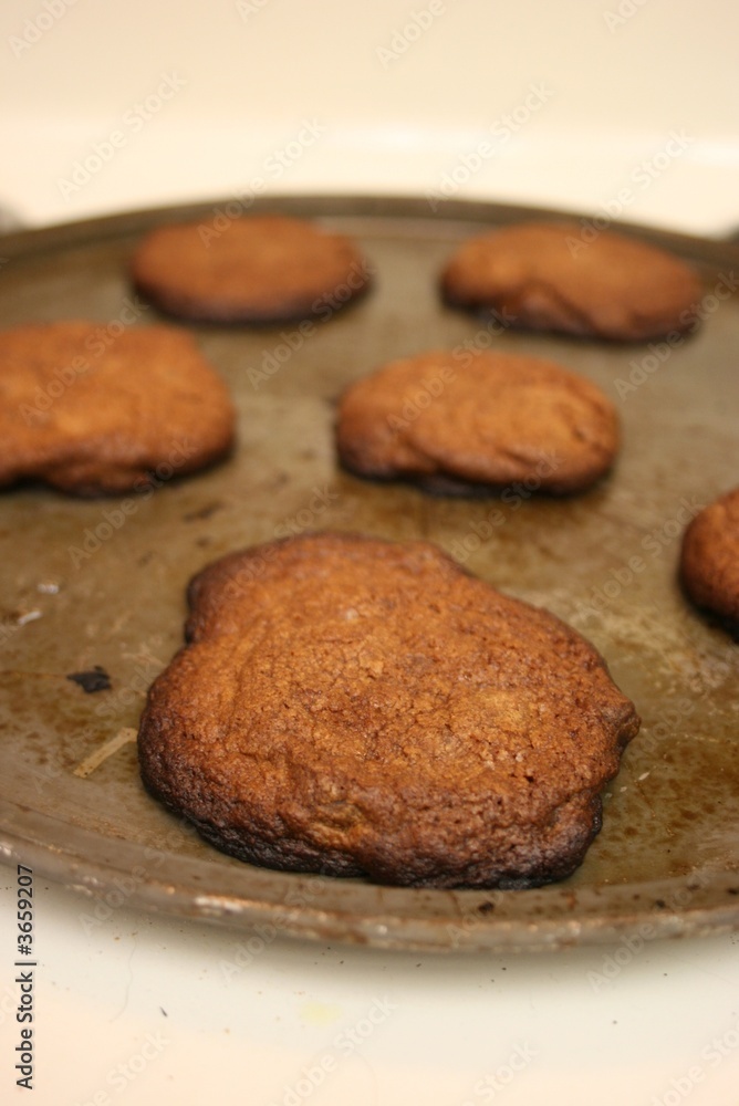 Close up view of a sheet of burnt cookies on a stove top Close up view of a sheet of burnt cookies on a stove top