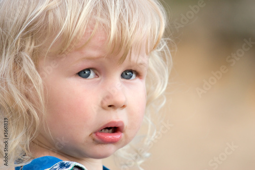 Tableau sur toile portrait of two years old sad blonde girl