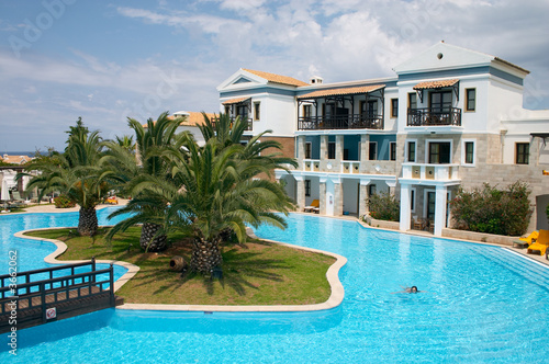 resort with swiming pool and palm tree