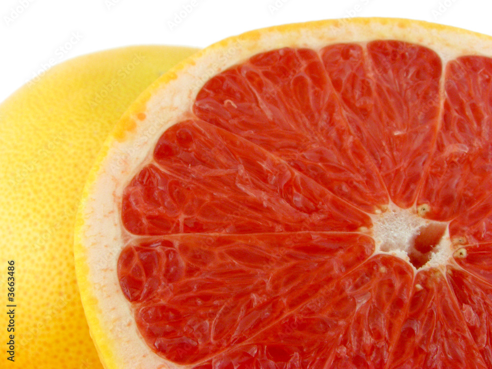 Slices of a grapefruit. A close up. Isolated on a white. Slices of a grapefruit. A close up. Isolated on a white.