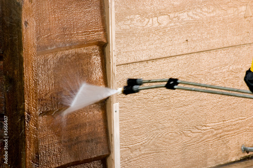 The side of a garage being pressure washed