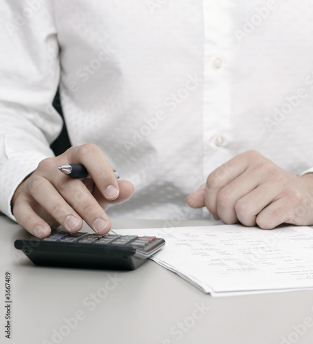 A businessman calculating expenses at tax time