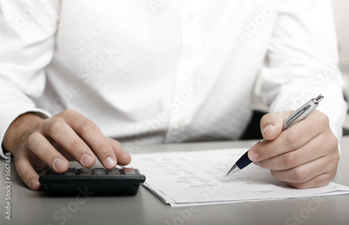 A businessman calculating expenses at tax time